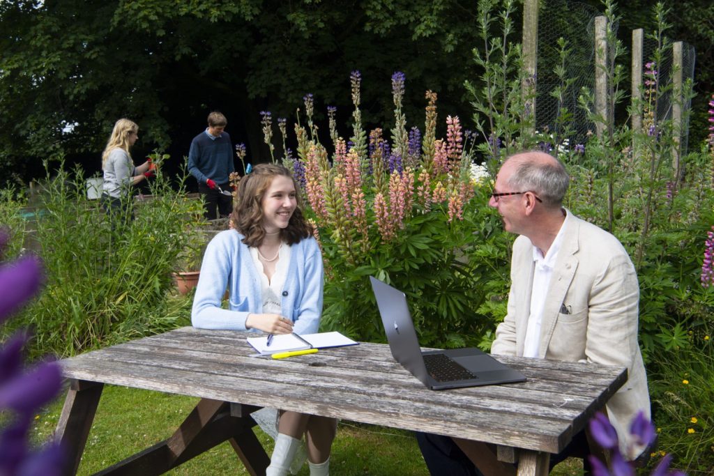 Students and staff in the gardens at Dumfries Campus